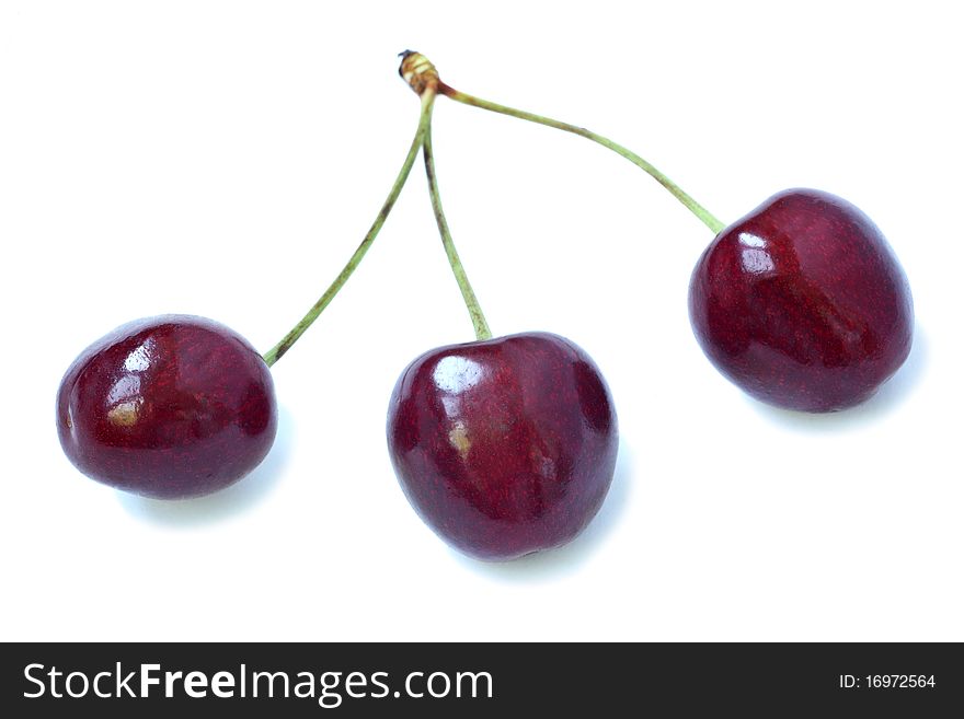 Three fresh sweet cherries on a white background. Three fresh sweet cherries on a white background