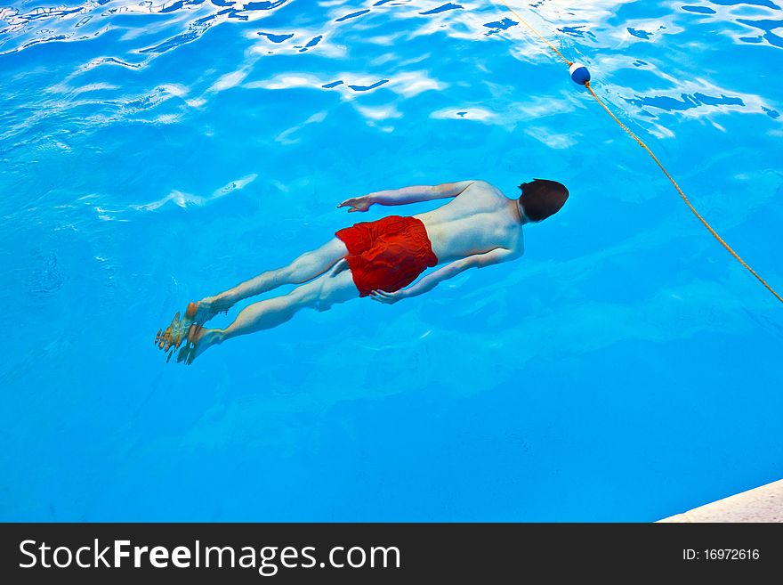 Boy  diving in the pool