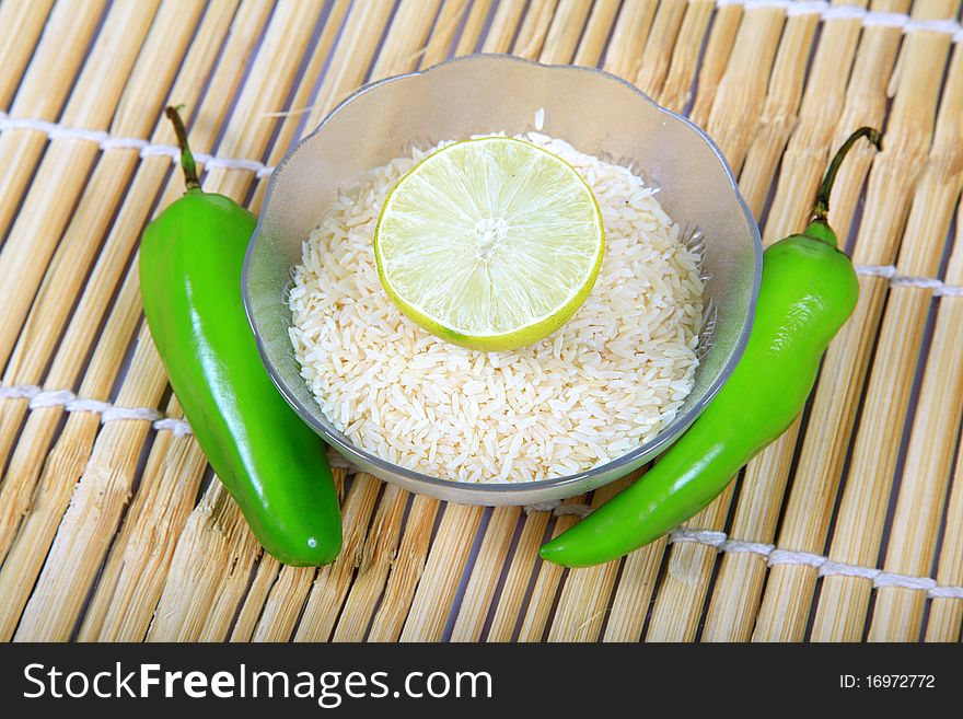 Chilly and lemon rice on wooden background.