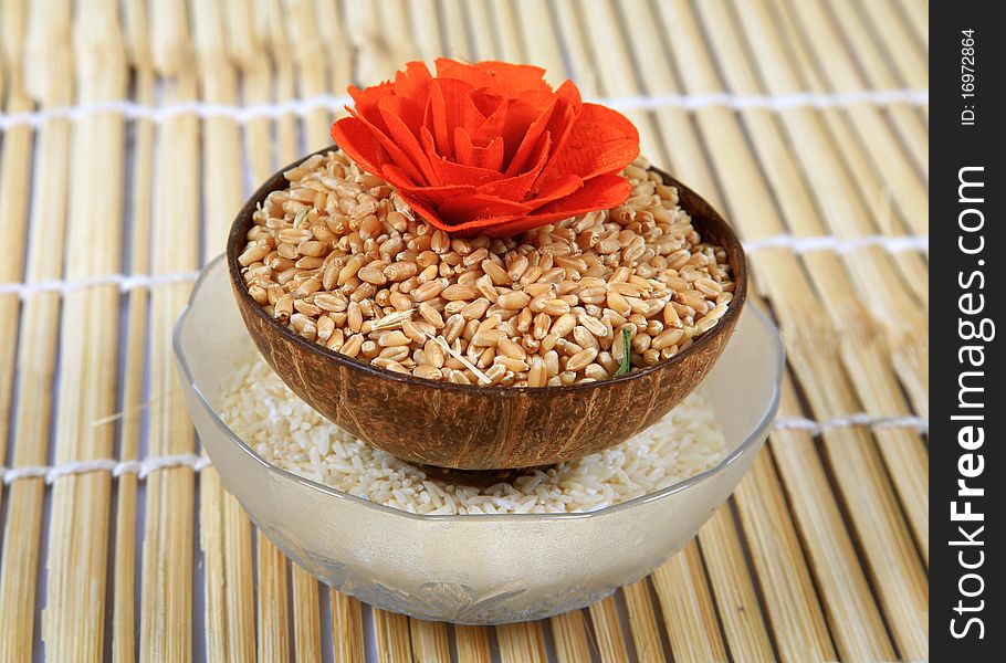 Wheat and rice bowls over wooden background.