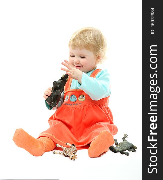 A Baby Playing With Toy Animals Isolated On White