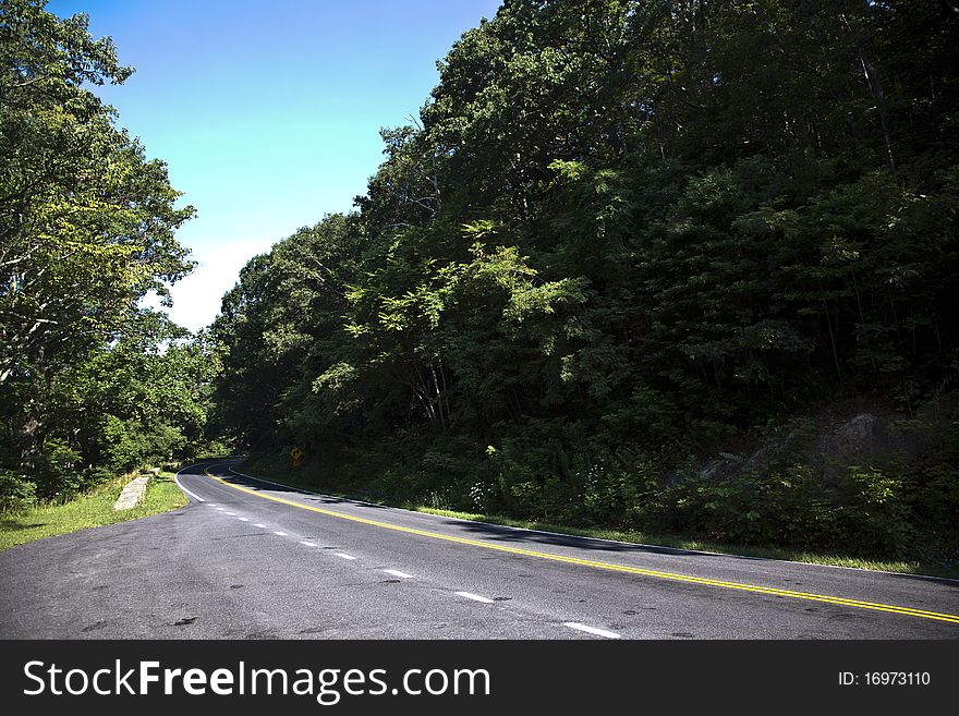 Beautiful scenic country road curves through Shenandoah National Park. Beautiful scenic country road curves through Shenandoah National Park.