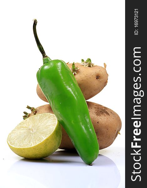 Food ingredients green chilly, potatoes and lemon isolated on white background.