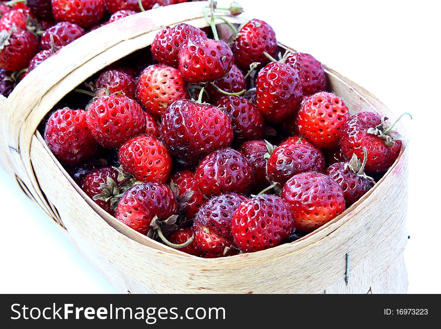 Wild strawberry in a basket on a white background