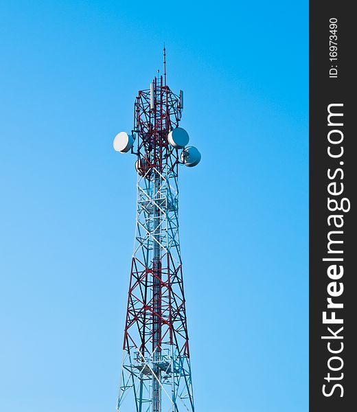 Mobile phone communication repeater antenna tower in blue sky