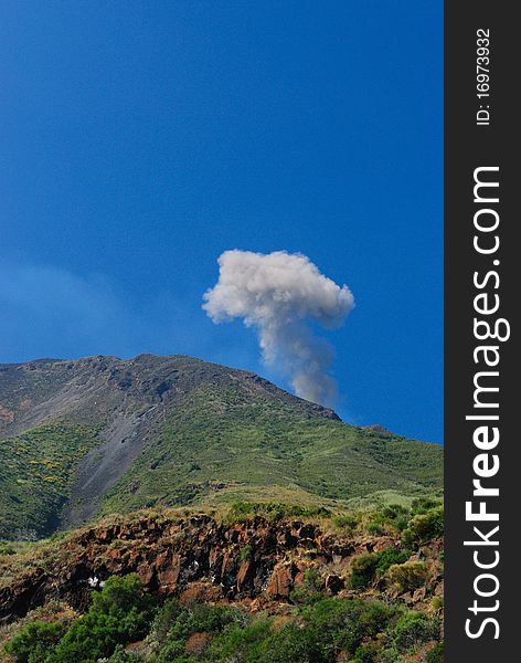 Strombolis volcan explosion with blue sky background