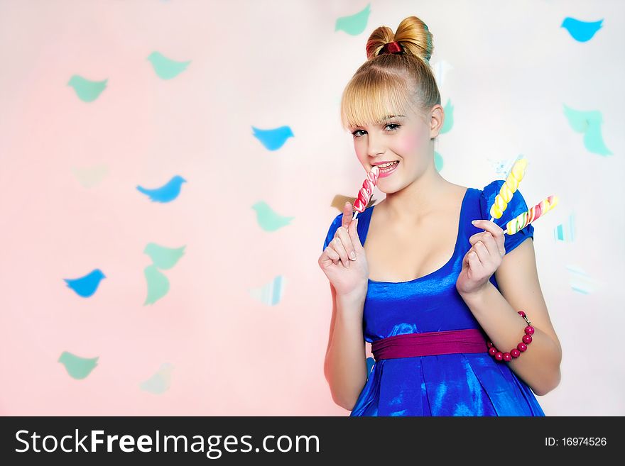 Studio portrait of young girl with lollypops