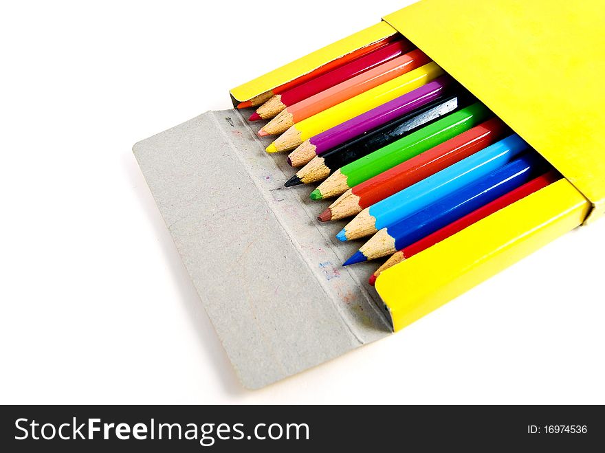 Used color pencils in yellow box isolated