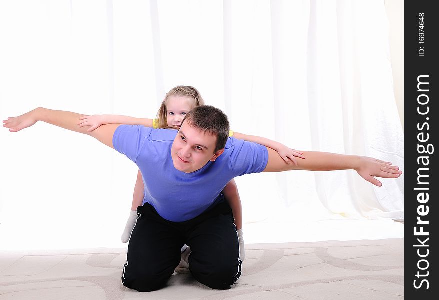 A young father has fun with his daughter