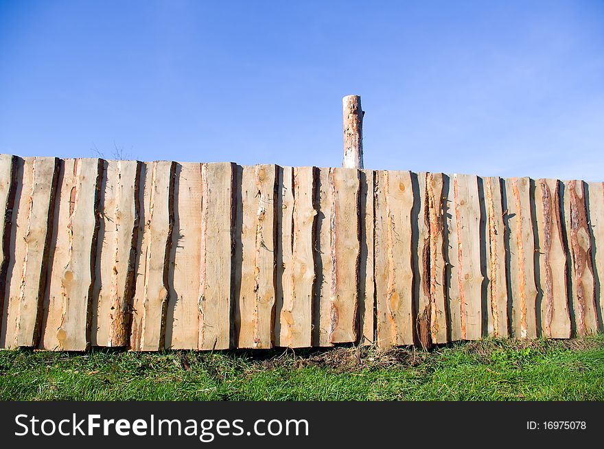 Wooden fence against blue sky. Wooden fence against blue sky