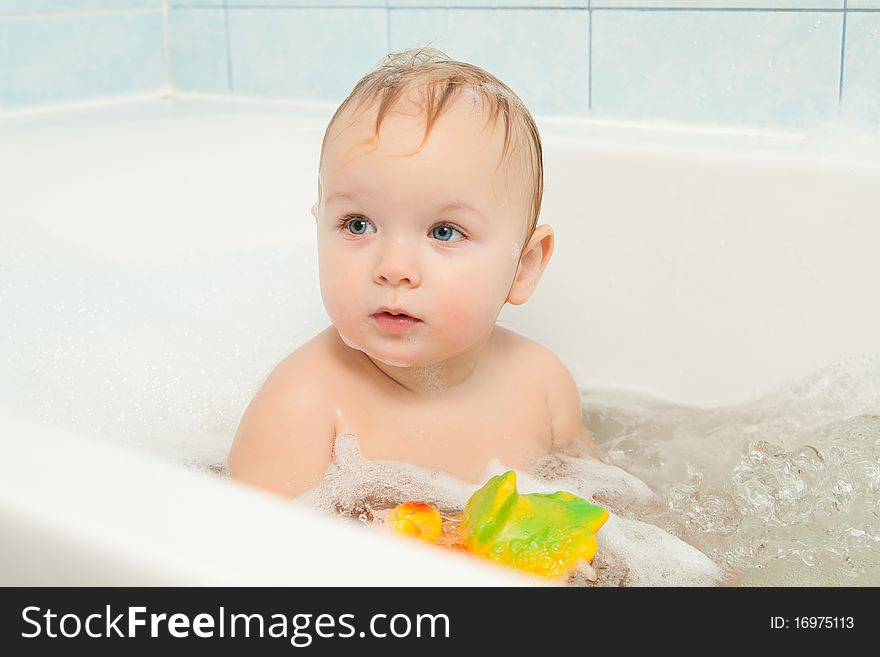 Cute adorable baby play with toy sitting in foam bath. Cute adorable baby play with toy sitting in foam bath