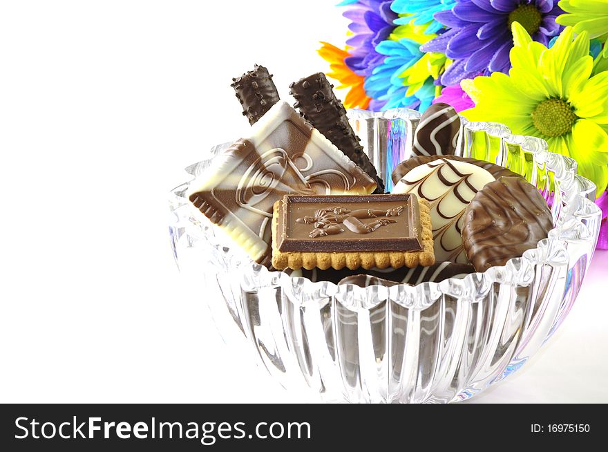 Chocolate and flowers on a white background