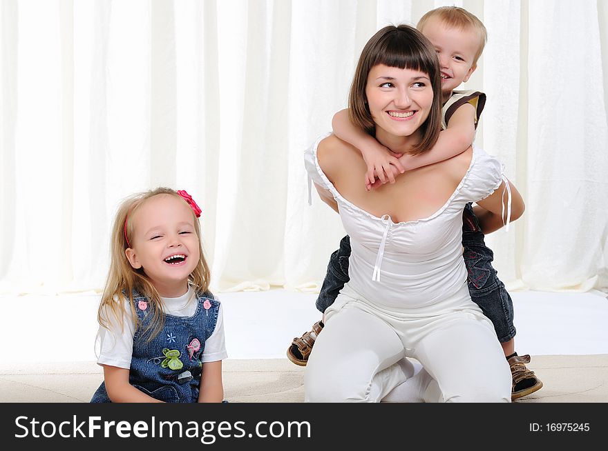 A young mother, her daughter and son having fun together