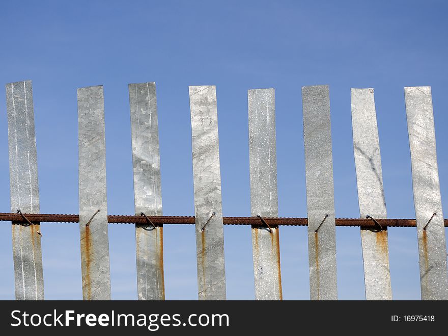 Metallik fence on blue sky background