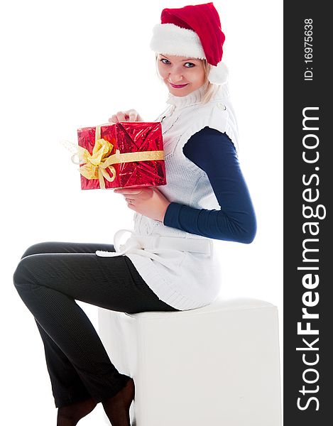 Christmas girl sits and hold a gift.  Isolated on white