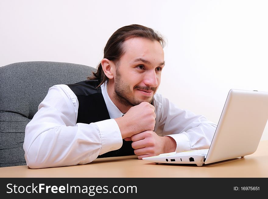 A young business man working on the computer in the office.