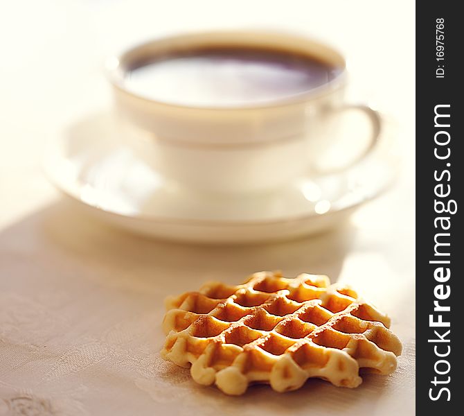 Hot coffee with wafers, close-up