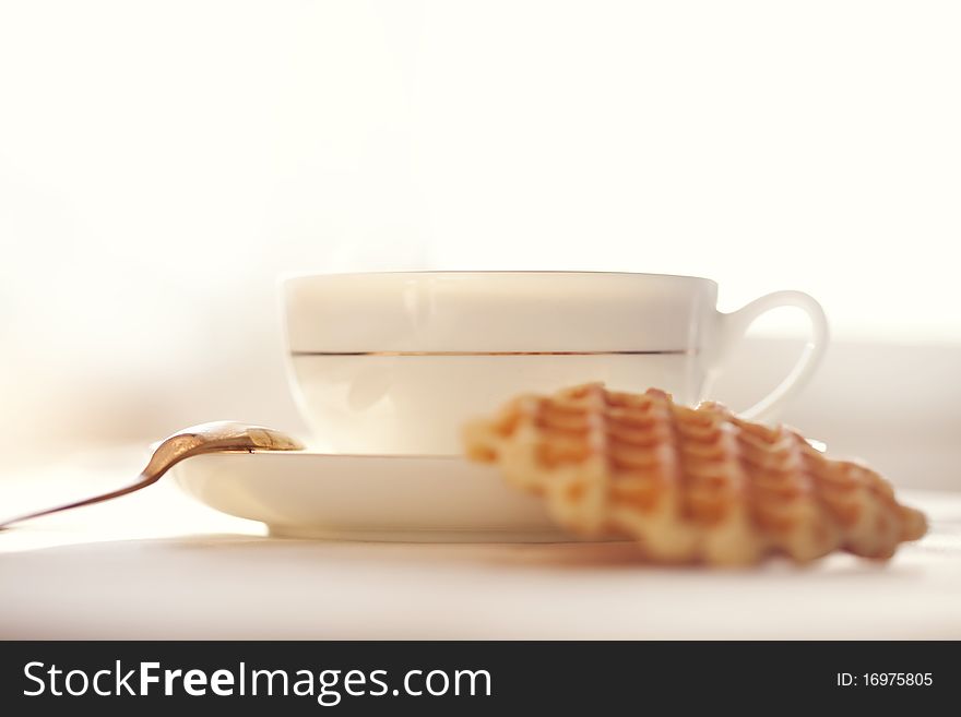 Hot coffee with wafers, close-up