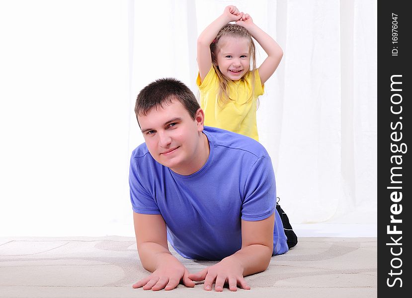 A young father has fun with his daughter