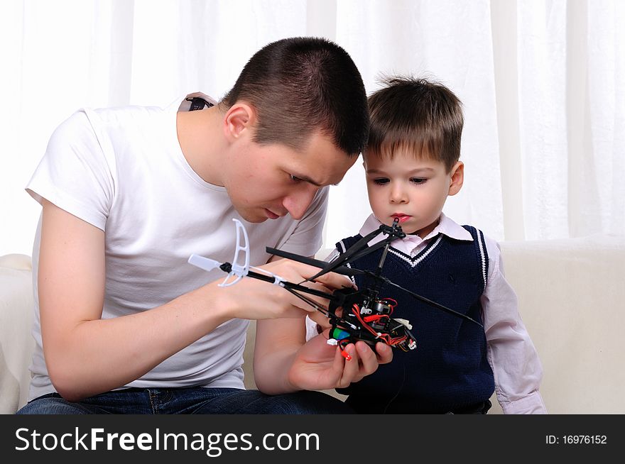 Father and his young son together renovating a small helicopter