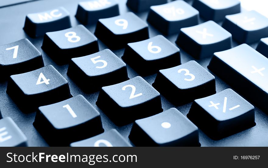 Buttons close up of the calculator with dark blue toning. Buttons close up of the calculator with dark blue toning