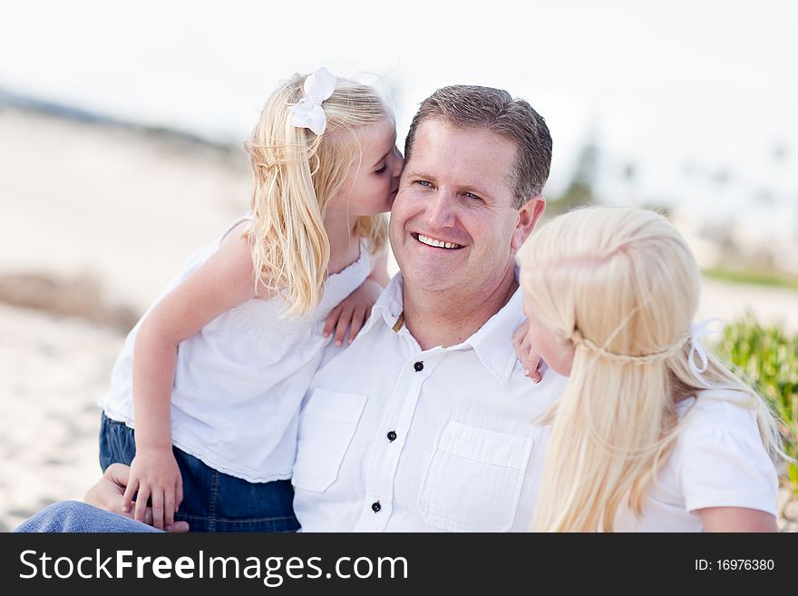 Handsome Dad Getting Kisses from His Cute Daughters at The Beach.