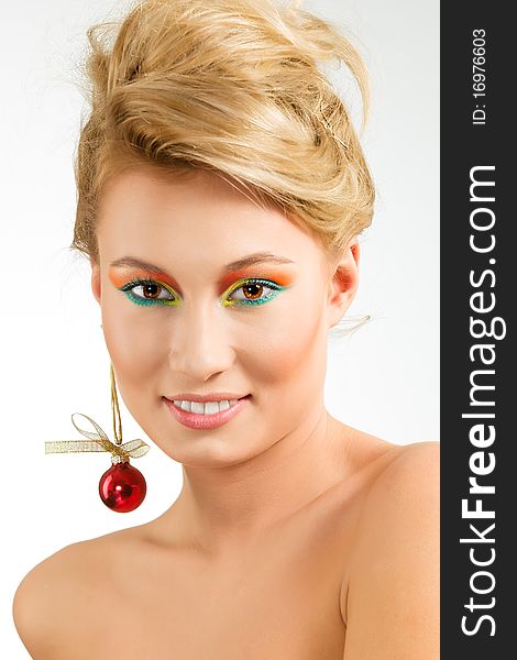 Amazing smiling young woman with earring from xmas ball. Amazing smiling young woman with earring from xmas ball