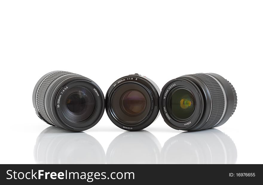 A set of three lenses for DSLR camera on a white background