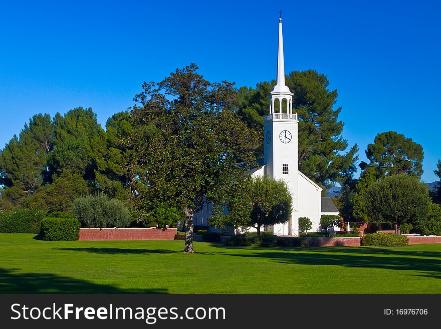 Small church with steeple in pastoral setting. Small church with steeple in pastoral setting.