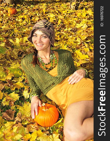 Cute young woman lying in yellow autum leaves. Cute young woman lying in yellow autum leaves