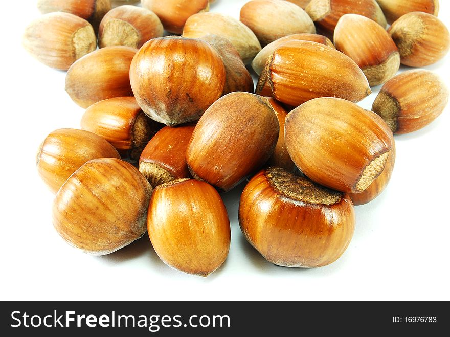 Brown hazelnuts isolated on white