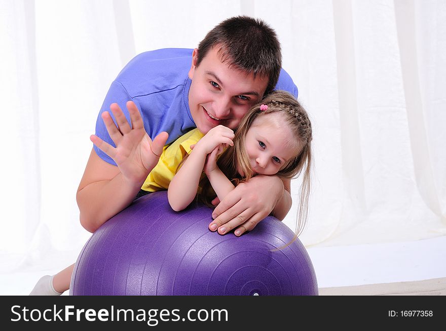 A young father and daughter together in sports