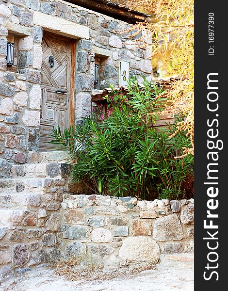 Old stone greek house entrance in a village