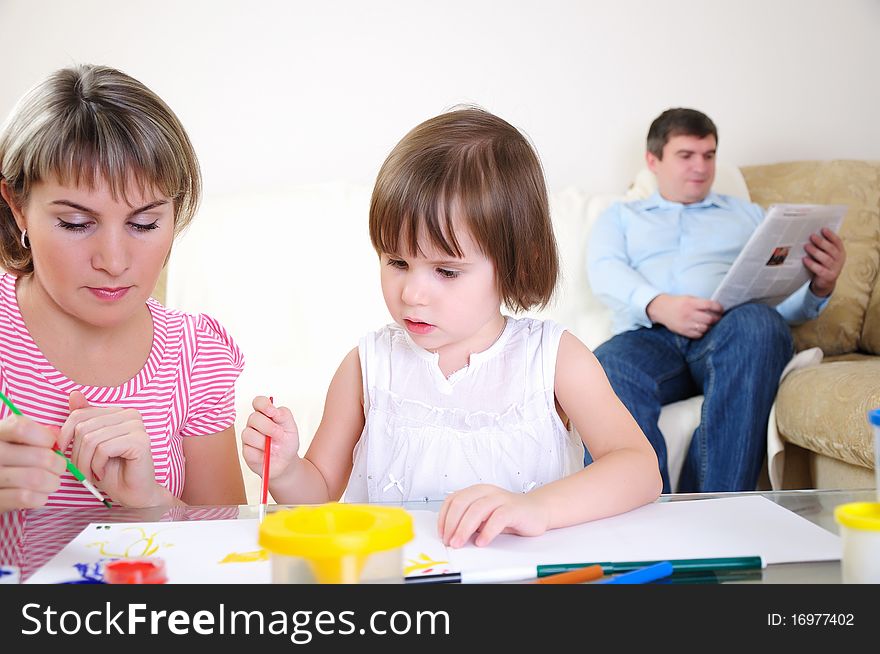 Mother and daughter together paint an album and have fun together.