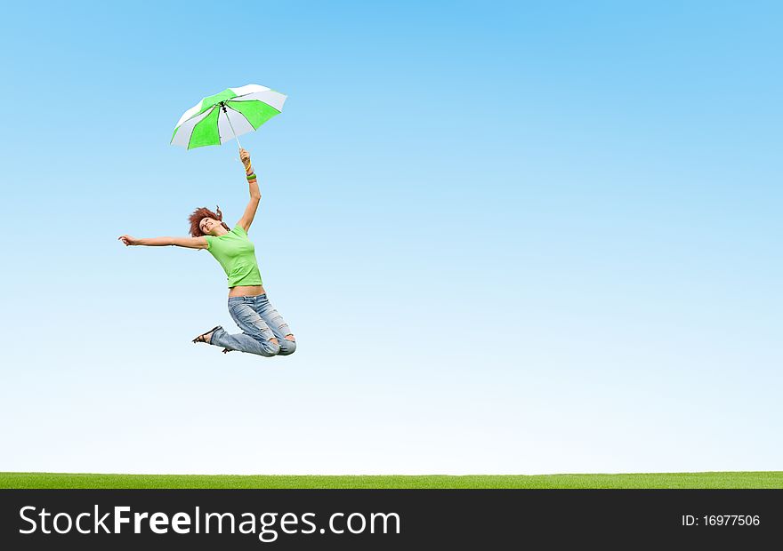 Young girl jumping with umbrella