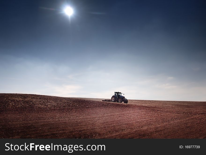 Tractor afield and blue sky