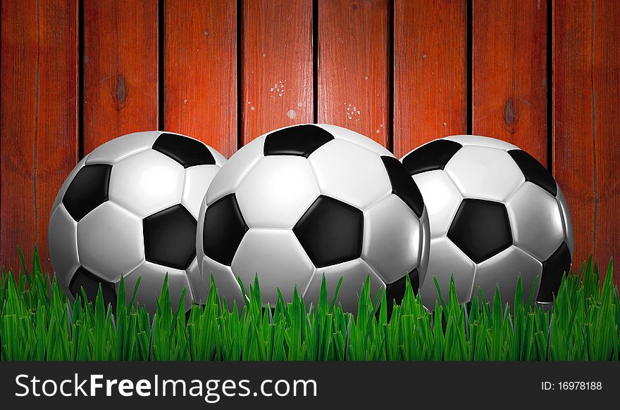 Footballs on green grass , training on wood background