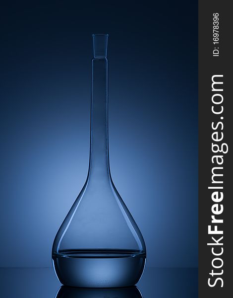 Flask with liquid and blue background