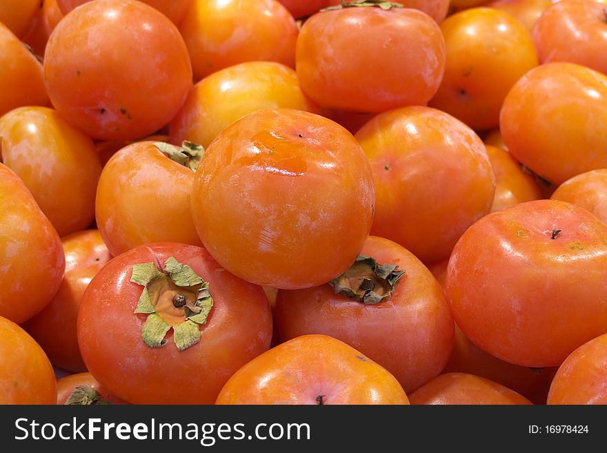 Fresh persimmon in stack, shown as raw, fresh, crude and healthy fruit. Fresh persimmon in stack, shown as raw, fresh, crude and healthy fruit.