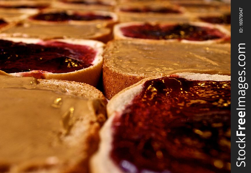 Seemingly endless supply of peanut butter and jelly sandwiches being assembled. Seemingly endless supply of peanut butter and jelly sandwiches being assembled.