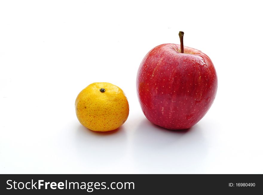 Tangerine and apple isolated on white