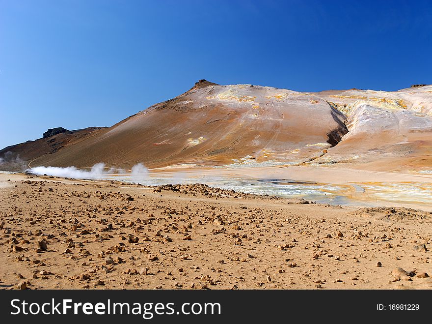 Blue sky, red earth and steam in Iceland. Blue sky, red earth and steam in Iceland