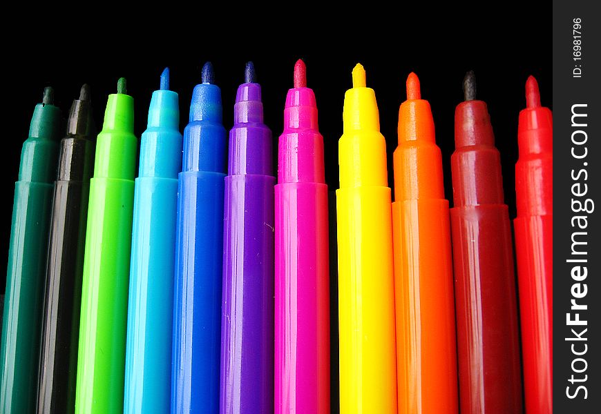 A background of plastic colorful sketch pens, used for drawing and sketching. A background of plastic colorful sketch pens, used for drawing and sketching.