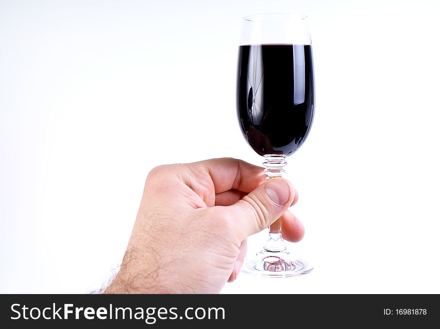 Wineglass in mans hand on white backgrounds. Wineglass in mans hand on white backgrounds