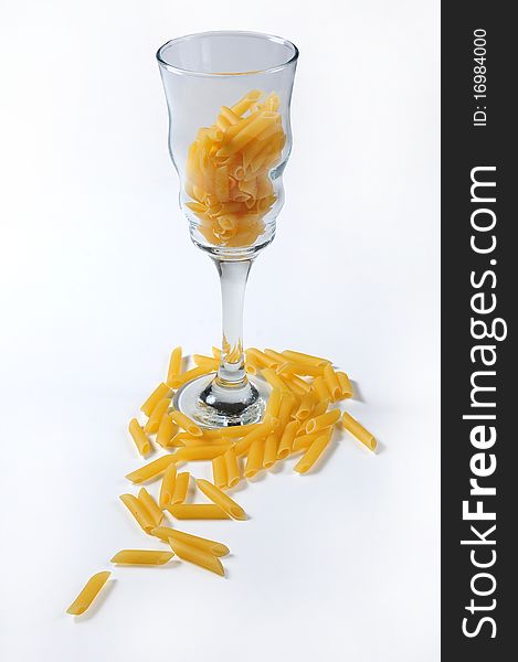 picture of wheat macaroni, with glass of it digs and white bottom
