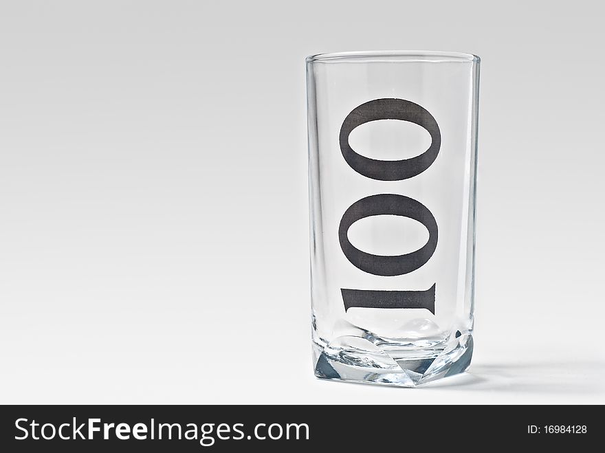 Isolated empty 100 glass with light shadow