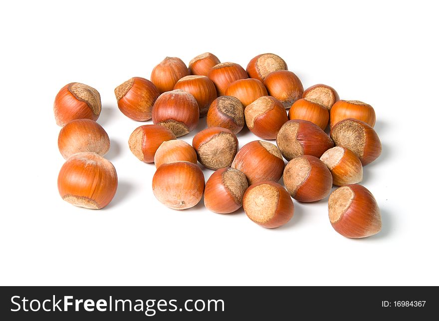 Pile of hazelnuts on a white background