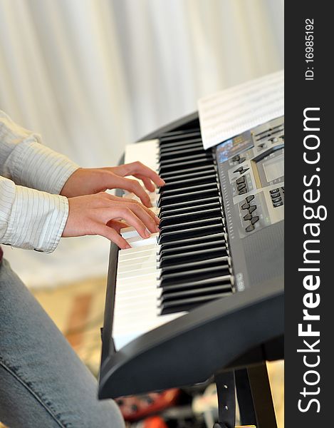A woman's hands playing the Electronic piano. A woman's hands playing the Electronic piano