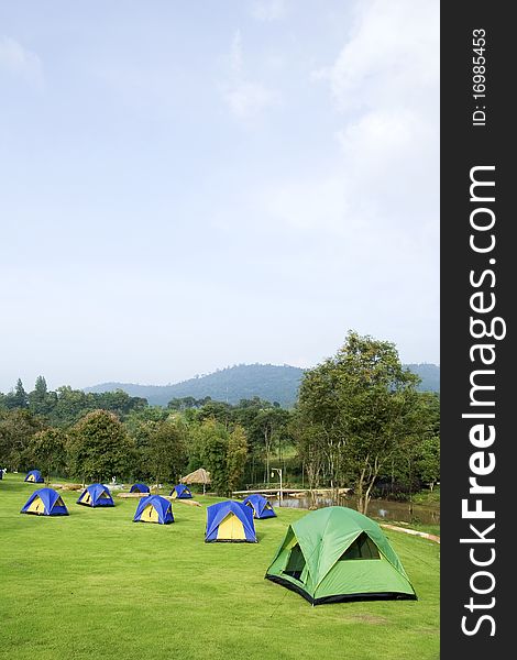 Many tents put on green grass. Many tents put on green grass