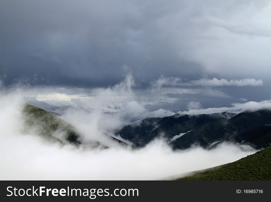 Clouds covering tip of moutain